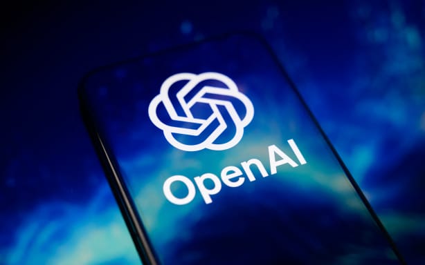 The OpenAI logo is displayed on a smartphone screen placed on a reflective surface onto which a blue abstract illustration is projected, in Creteil, France, on June 9, 2026. OpenAI confirms it has confidentially filed a prospectus for an initial public offering with the Securities and Exchange Commission.