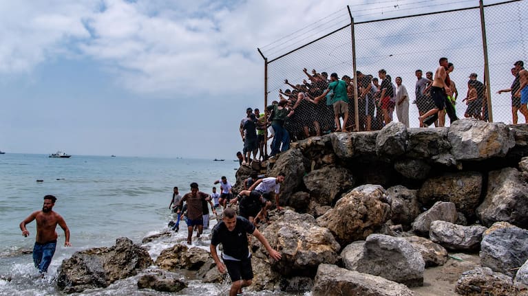Migrants cross from Morocco into the Spanish enclave of Ceuta.