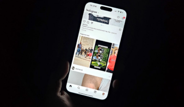 A hand holds an iPhone 13 Pro Max