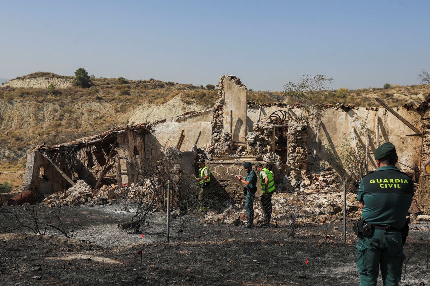 Members of the Spanish Civil Guard conduct an investigation during a wildfire in Almocaizar, in the vicinity of Los Gallardos, Spain, on Friday.