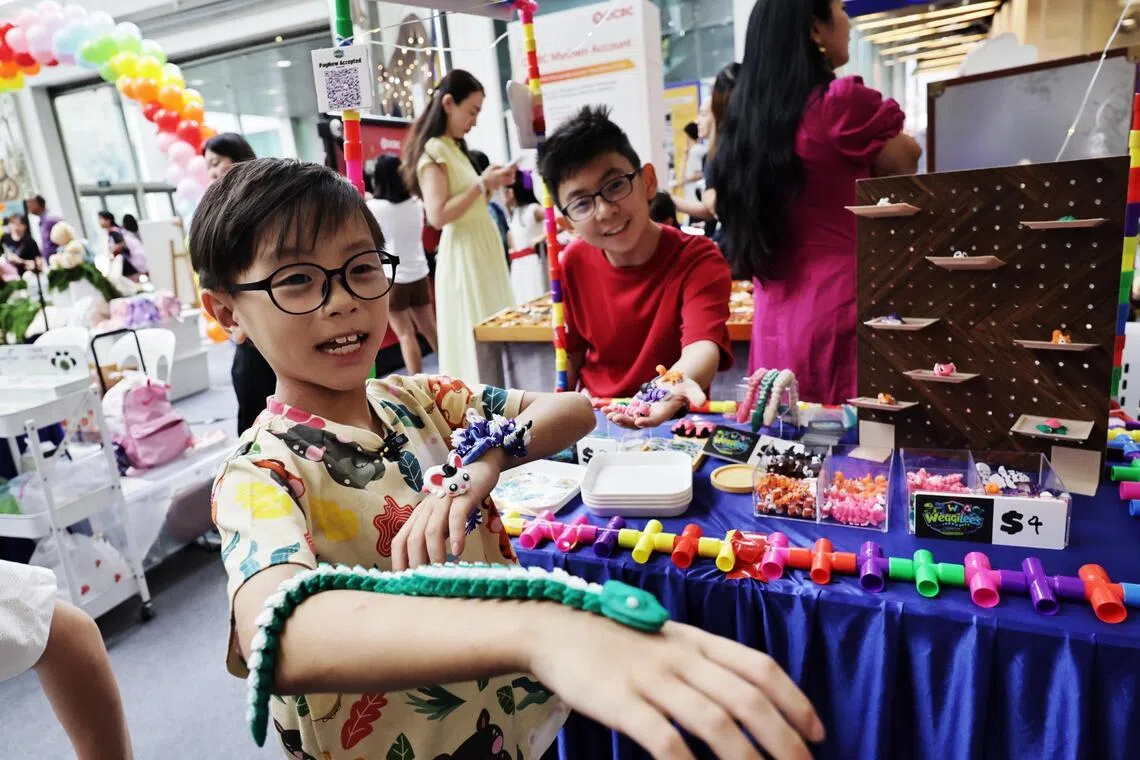 Lee Rui Qi with his 3D-printed animal figurines at Singapore Kidpreneurs at HarbourFront Centre.