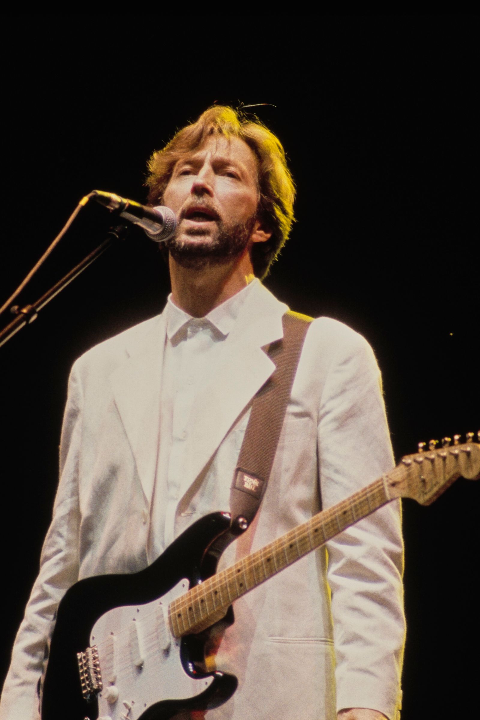 Image may contain Eric Clapton Guitar Musical Instrument Adult Person Electrical Device Microphone and Performer
