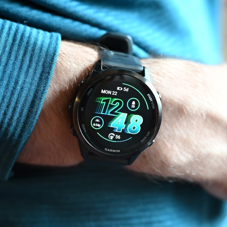 A close-up of the Garmin Forerunner 570 on the wrist of the writer.
