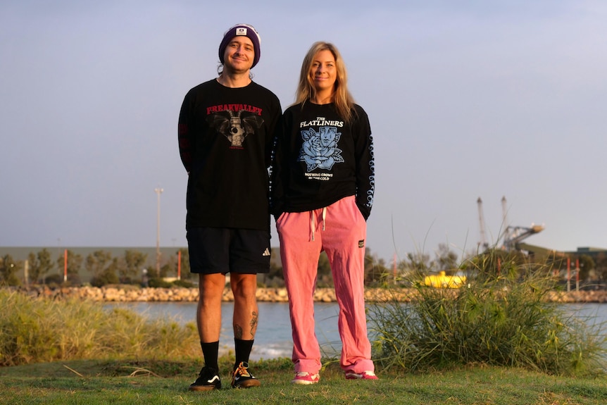 Jaz and Ken McCartney stand together at the beach