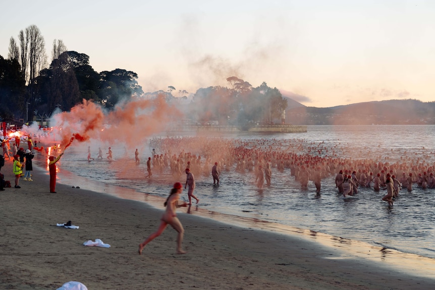 Naked swimmers take to the water for the 2026 Dark Mofo Nude Solstice Swim