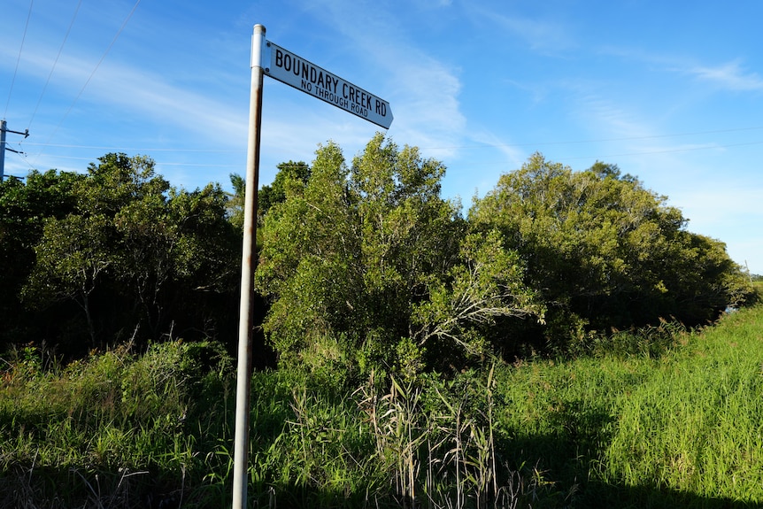road sign with vegetation