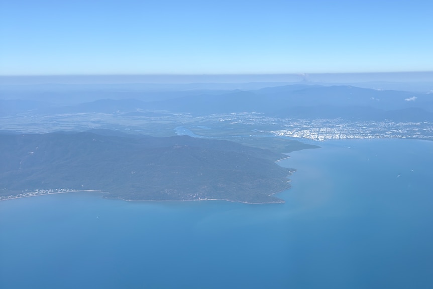 An overhead shot of coastal communities by the ocean.