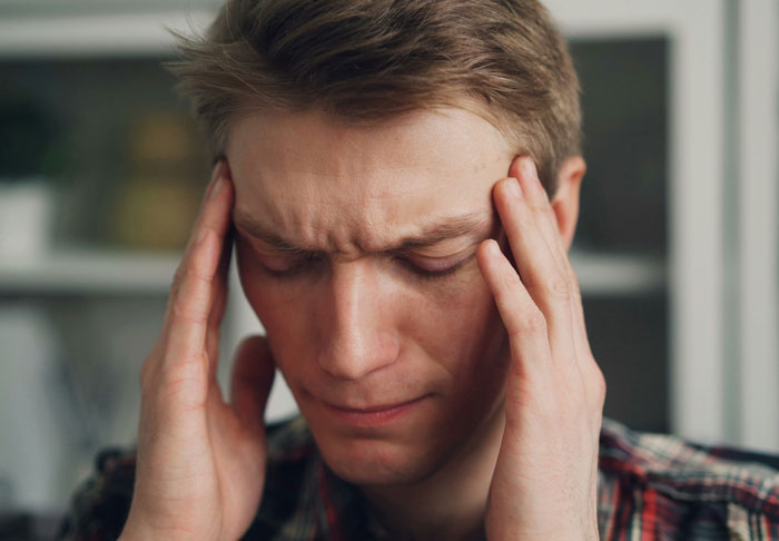 A male patient suffering from a severe headache, failing to outsmart their doctors.