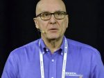 head and shoulders photo of soil scientist Rigas Karamanos. Logo on shirt reads "Koch Agronomic Services LLC"