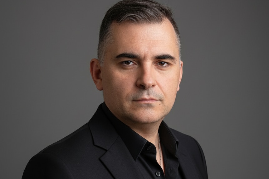 A close-up shot of a man looking at the camera.