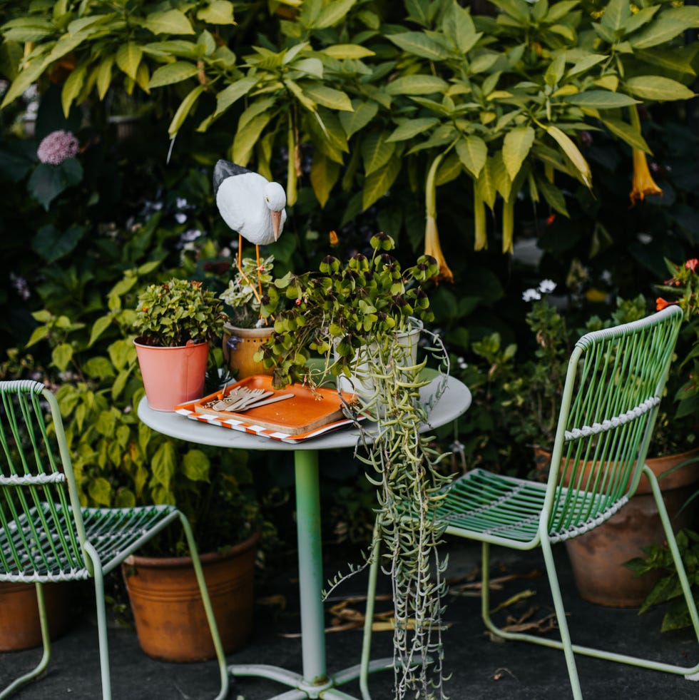 green garden furniture in a small garden.
