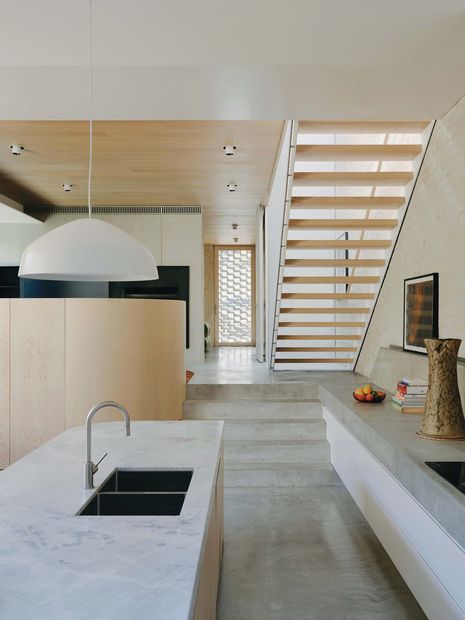 Stepped floor levels follow the fall of the site and create subtle distinctions between living zones.