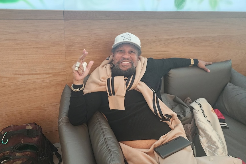 Village People lead singer Victor Willis reclining on a couch.