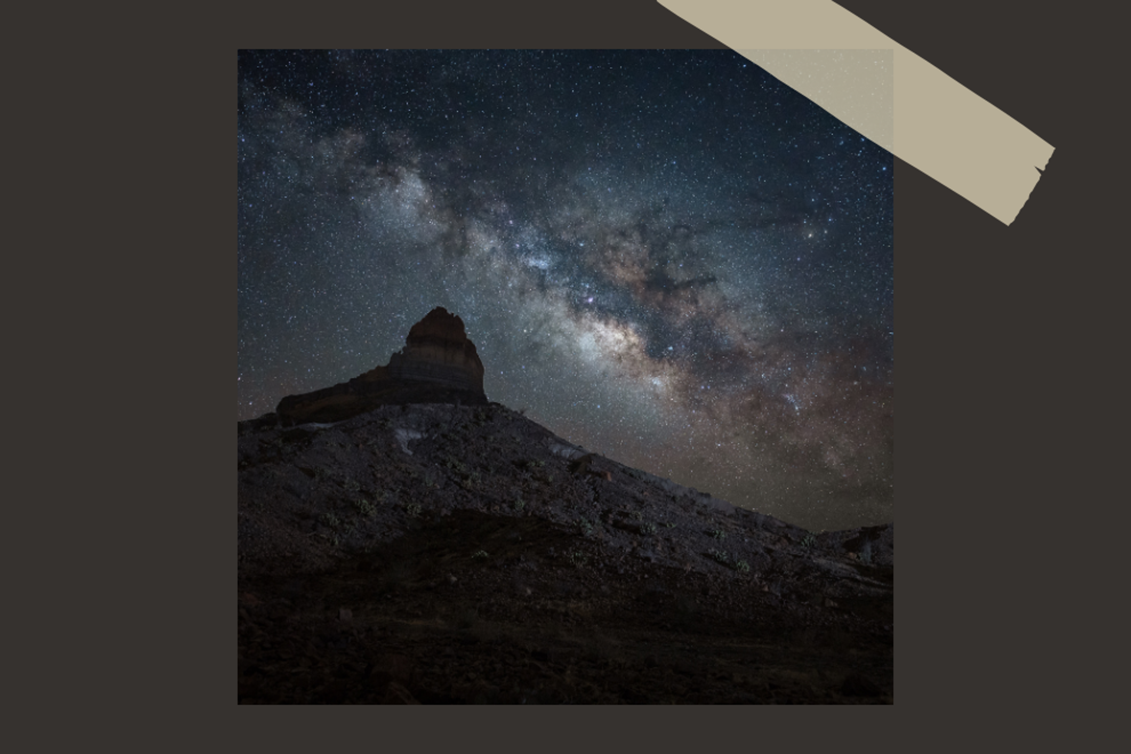 Milky way crossing the sky with mountain peak in the foreground taken in Big Bend Texas.