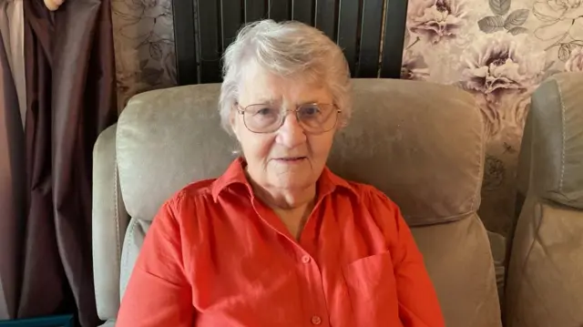 Elaine Yates sits in an armchair