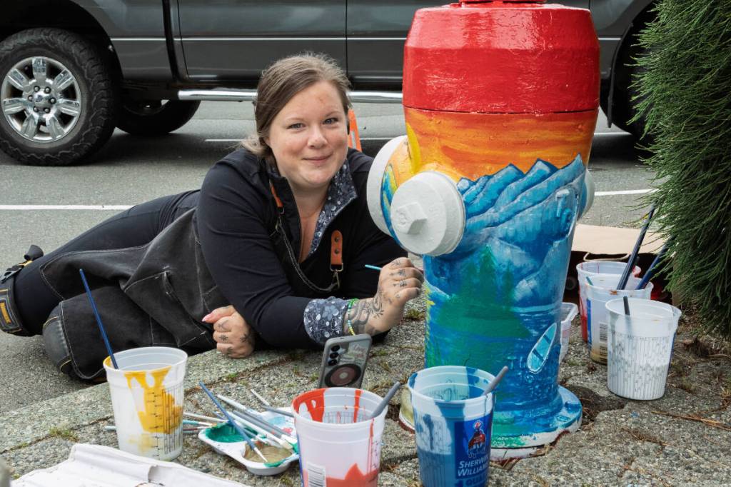 Mandy Phoenix works on her fire hydrant design at Harbour Quay on Friday, July 3. Phoenix was one of more than half a dozen artists chosen to participate in an HGTV Home Town Takeover community art project, repainting hydrants in Harbour Quay and up Argyle Street in vibrant colours. The artists’ inspiration for each design will be revealed as part of the reality TV show premiering in the fall. See more on page A7. (Roland Smith/ Alberni Valley News)