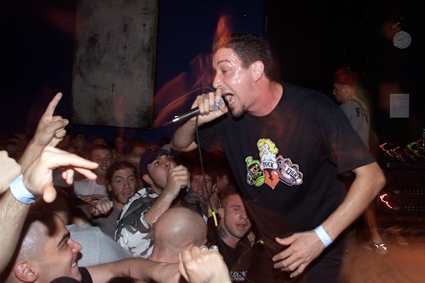 Sick Of It All lead singer Lou Koller get some help from fans while performing at the Knitting Factory in New York City
