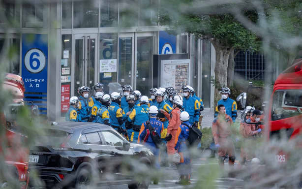 Emergency workers gather outside the Aeon Mall Kumamoto in Kashima, Kumamoto Prefecture, on July 29, 2026 after an earthquake struck the area. Two young women were found dead early Wednesday in a mall badly damaged by a powerful earthquake and subsequent explosion, local media reported, as crews continued searching overnight for missing people. (Photo by Yuichi YAMAZAKI / AFP)