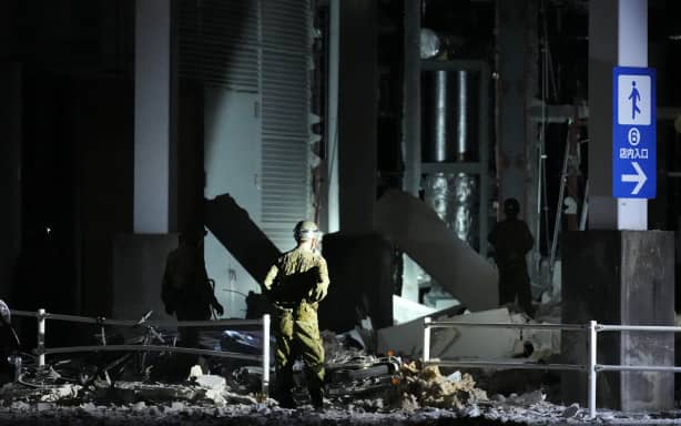 Japan Self-Defense Forces personnels search for missing people at AEON Mall Kumamoto following an explosion in Kashima Town, Kumamoto Prefecture, Japan, on July 29, 2026. The explosion occurred at the large shopping mall at around 6 p.m. on July 28 following an earthquake, causing part of the second floor to collapse and reportedly leaving many people trapped inside. According to the Japan Meteorological Agency, the quake struck Kumamoto Prefecture at around 4:27 p.m. that day, registered a maximum intensity of 7 on Japan's seismic intensity scale, originated at a depth of about 10 kilometers and had an estimated magnitude of 7.1. ( The Yomiuri Shimbun ) (Photo by Kazuki Wakasugi / The Yomiuri Shimbun via AFP)