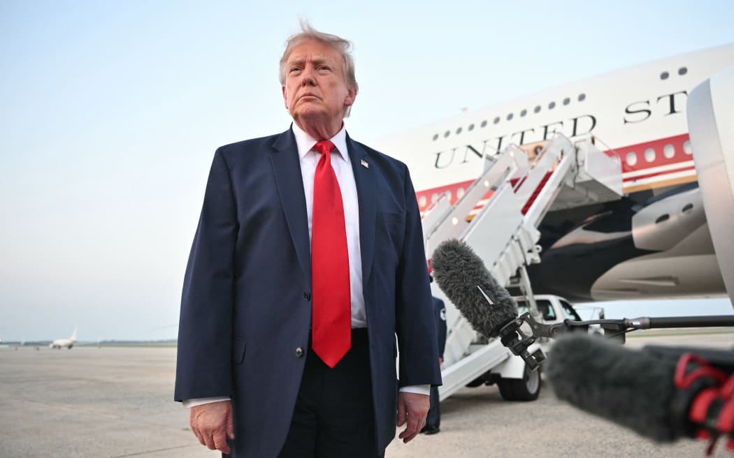 US President Donald Trump speaks to reporters after stepping off Air Force One upon returning to Joint Base Andrews in Maryland on July 19, 2026. Trump is returning to the White House from New Jersey, where he attended the 2026 World Cup Final. (Photo by Mandel NGAN / AFP)