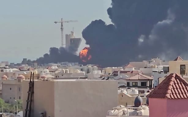 This screen grab taken from UGC video footage posted on social media on July 18, 2026, shows a plume of black smoke and flames billowing over the town of Mangaf, south of Kuwait City. Kuwait accused Iran on July 18 of targeting civilian sites and vital infrastructure in the country, after reporting attacks on an oil facility and a power and water plant. (Photo by various sources / AFP) / RESTRICTED TO EDITORIAL USE - MANDATORY CREDIT AFP - SOURCE: UGC / UNKNOWN - DISTRIBUTED AS A SERVICE TO CLIENTS - NO ARCHIVE - NO RESALE - NO USE AFTER: JULY 27, 2026 15:00:00 GMT