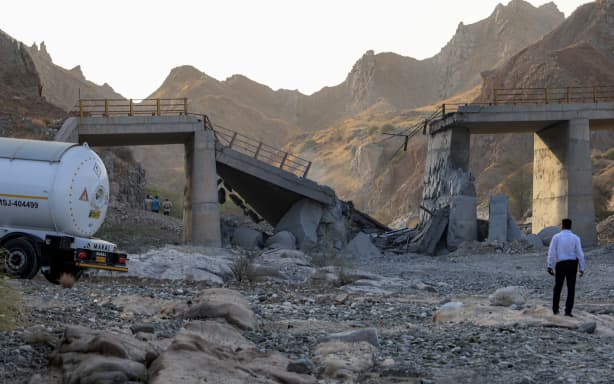 A heavily-damaged bridge which was hit by a US strike is pictured along the road connecting Roudan and Bandar Abbas in southern Iran on July 18, 2026. The United States hit Iran on July 17, with Tehran accusing US forces of striking civilians sites and drawing Iranian threats of reprisals on regional infrastructure. A battle over the strategic Strait of Hormuz has rekindled the war in the Middle East and the foes have traded fire for six days running. (Photo by Amir Hossein KHORGOOEI / ISNA / AFP) /