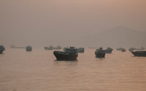 Vessels are anchored in the Strait of Hormuz as seen from Musandam, Oman, on June 3.