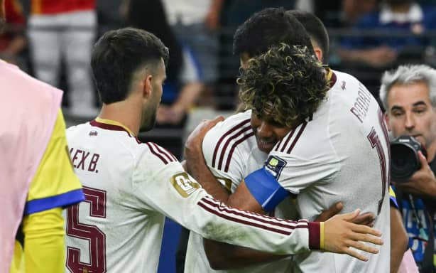 Spain's forward #19 Lamine Yamal (C) and Spain's midfielder #16 Rodri (R) embrace as they celebrate their team's victory at the end of the 2026 World Cup football tournament semi-final match between France and Spain at the Dallas Stadium in Arlington on July 14, 2026.  (Photo by RONALDO SCHEMIDT / AFP)