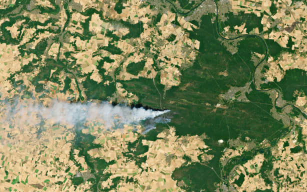 This satellite image taken by Copernicus Sentinel Data 2026 on July 13, 2026 shows the smoke from a wildfire in the forest of Fontainebleau,southeast of Paris. The fire that broke out on July 12 and swept through 800 hectares of the Fontainebleau forest, southeast of Paris, "could" have been "deliberately started," France's Interior Minister stated at the scene on July 13, 2026. (Photo by Handout / COPERNICUS SENTINEL DATA 2026 / AFP) / RESTRICTED TO EDITORIAL USE - MANDATORY CREDIT "AFP PHOTO / COPERNICUS SENTINEL DATA 2026 " - HANDOUT - NO MARKETING NO ADVERTISING CAMPAIGNS - DISTRIBUTED AS A SERVICE TO CLIENTS