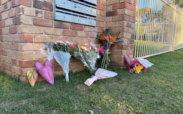 Floral tributes have been placed outside Ms Armstrong's home.