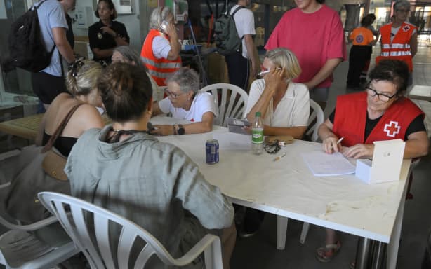 Evacuees from Bedar are registered in the sports hall of Garrucha, near Los Gallardos, in Almeria Province, on July 10, 2026 after a wildfire killed 11. Eleven people were killed and 19 are missing in the area of the village of Bedar after a wildfire tore through a Spanish village, with four victims who may have been British who were burned in their car, authorities said. (Photo by Jose JORDAN / AFP)