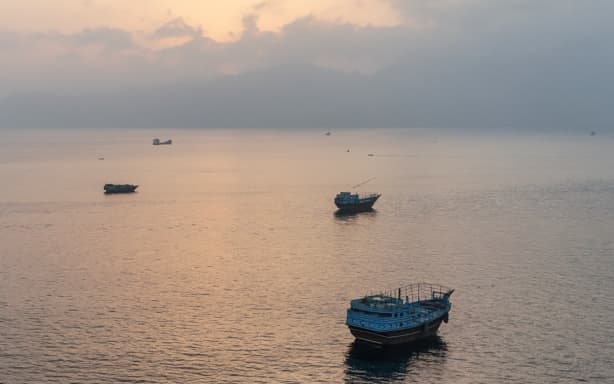 This aerial photograph shows boats anchored off Oman’s northern Musandam Peninsula near the Strait of Hormuz on June 27, 2026. /