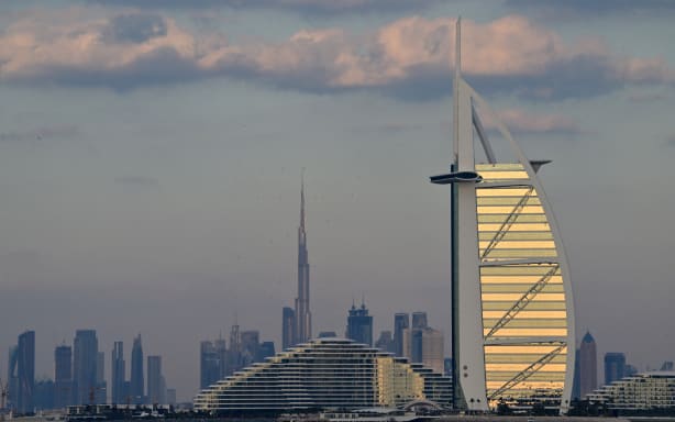 The Burj al-Arab tower and Burj Khalifa, the world’s tallest building, are pictured with the rest of the Dubai skyline on January 4, 2025. (Photo by Giuseppe CACACE / AFP)