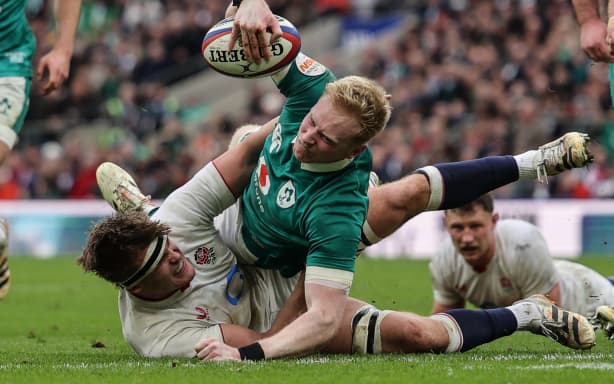 Ireland's full-back Jamie Osborne (C) goes over the line to score a try during the Six Nations international rugby union match between England and Ireland at Allianz Stadium, Twickenham, in south-west London, on February 21, 2026. (Photo by Adrian Dennis / AFP)