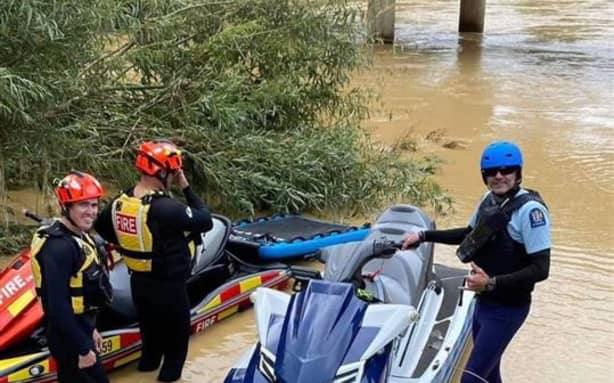Ngāruawāhia volunteer fire station's jet skis assist police with a water rescue during Cyclone Hale in 2023.