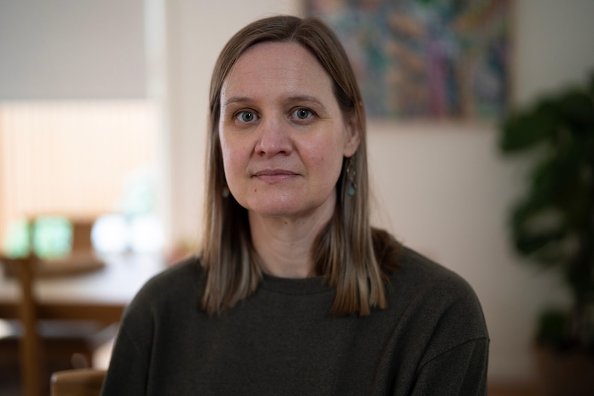 Woman with brown hair looking at camera