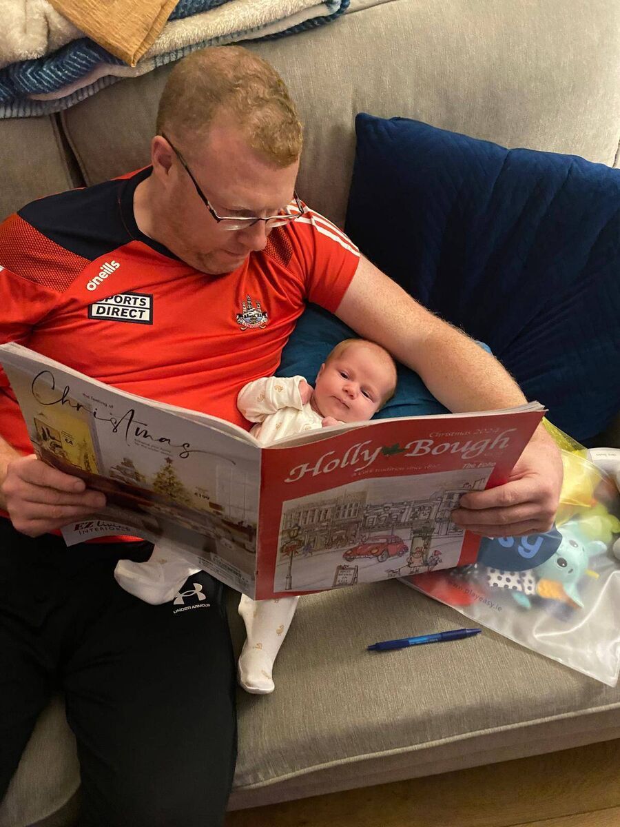 Chris Bowles and daughter Abbie Bowles reading last year's Holly Bough. 