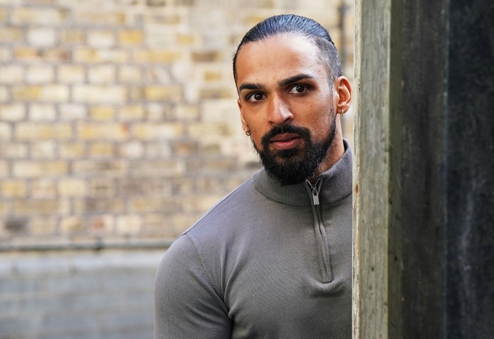566668,TITLE:Eastenders Ravi looks around a corner in a scene from EastEnders