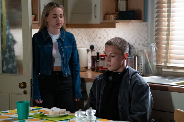 566703,TITLE:Eastenders Amy stands over Joel at the dining table in a scene from EastEnders
