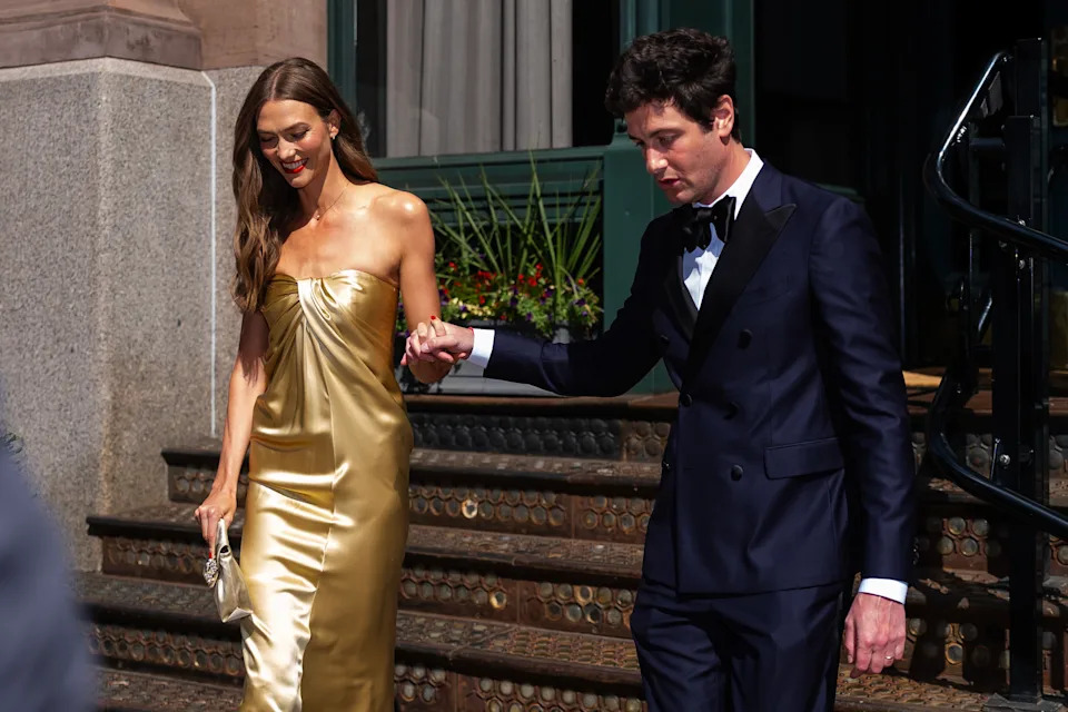 The model donned a gold strapless dress for the occasion and accessorized with a matching purse and heels while Kushner wore a classic suit and bow tie (as seen here). GC Images