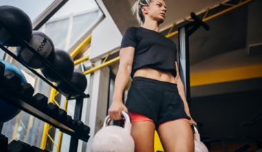 A woman performing kettlebell loaded carries