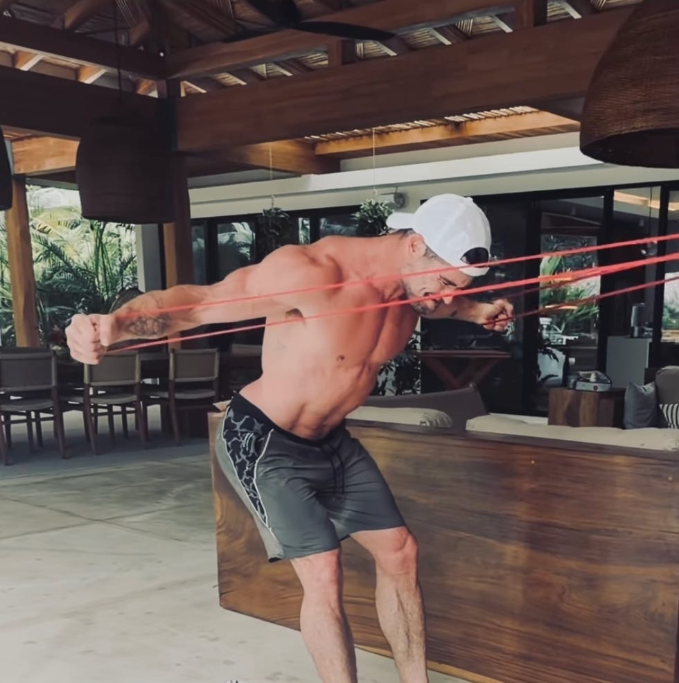 man exercising with resistance bands indoors. man exercising with resistance bands indoors.