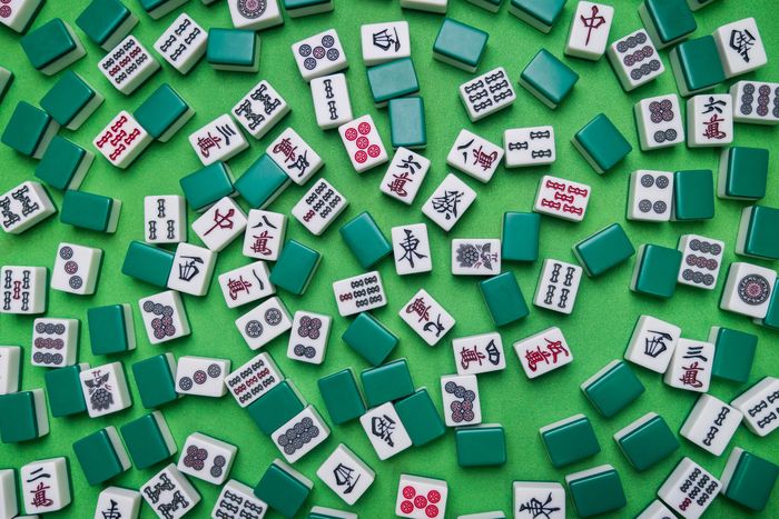 Full of Mahjong tiles game on green background