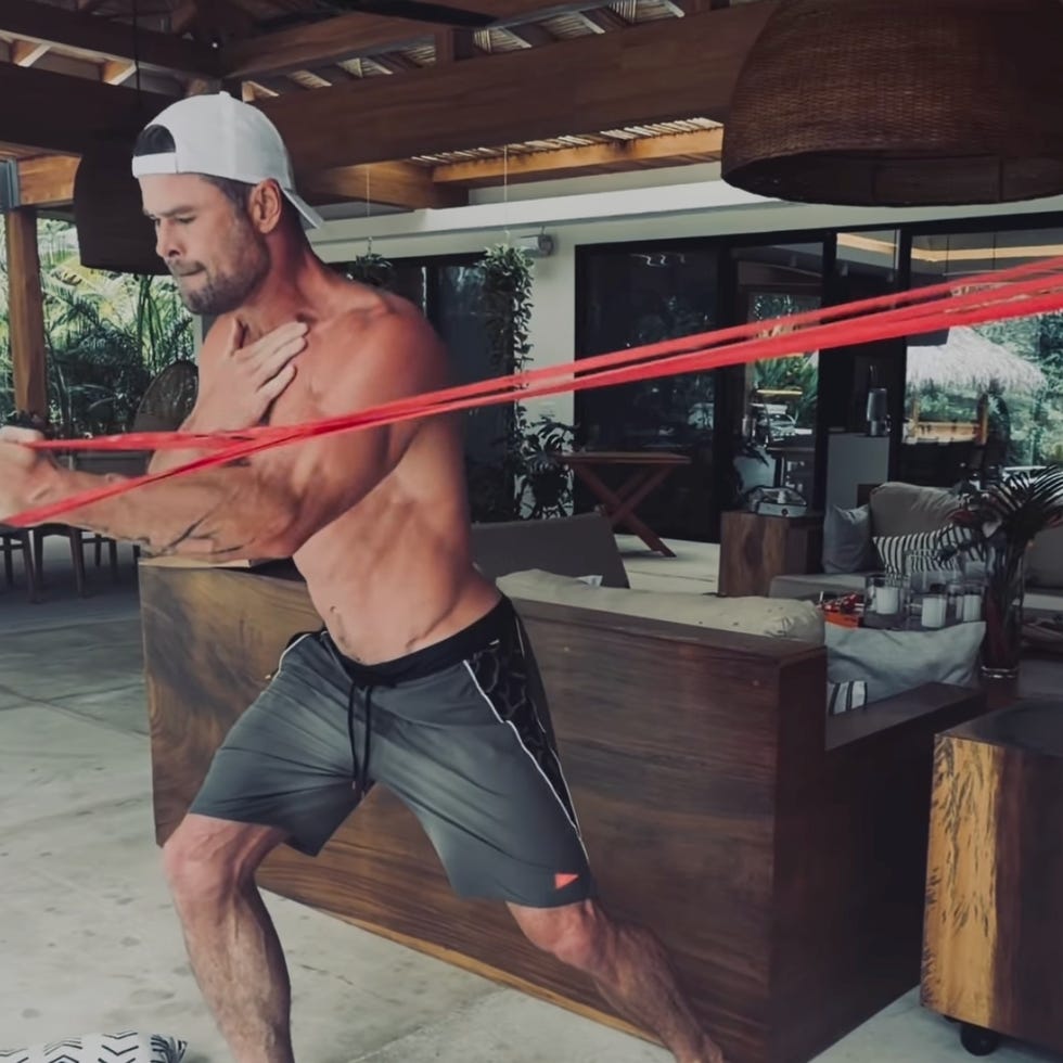man exercising with resistance bands indoors. man exercising with resistance bands indoors.