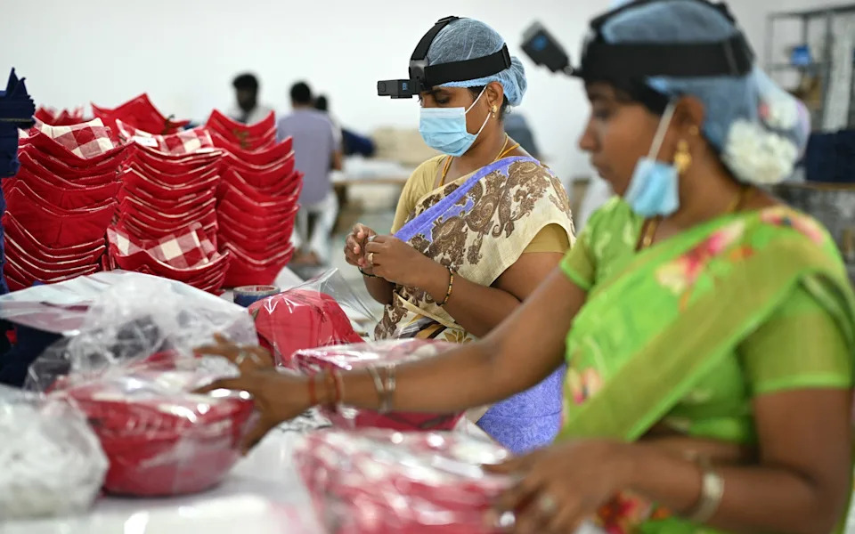 Women with GoPro cameras collect 'egocentric data' while they work inside a factory in Tamil Nadu, India