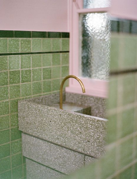 The bathroom is a study in restraint, with the new jade green terrazzo basin one of few additions.