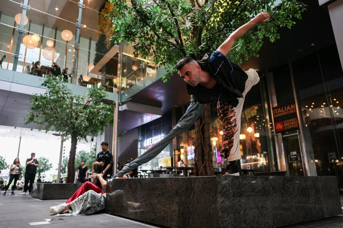 Performers presenting Dis.connected Body, a roving performance by Sigma Contemporary Dance in collaboration with the Singapore Art Museum, at Asia Square Tower 1 on July 1, 2026. The performance is part of the Singapore Art Museum's first public art trail in Singapore's Central Business District.ST PHOTO: BRIAN TEO