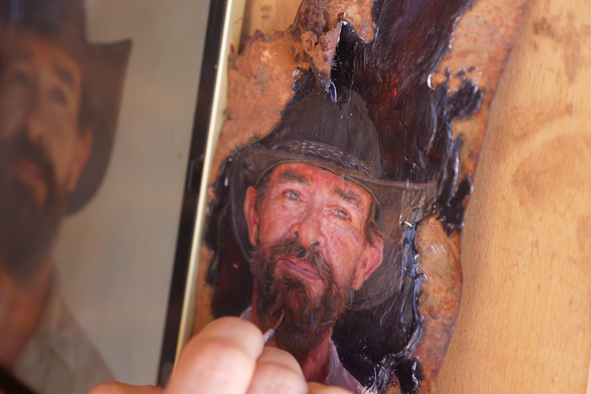 Detailed painting of a man on a piece of tin.