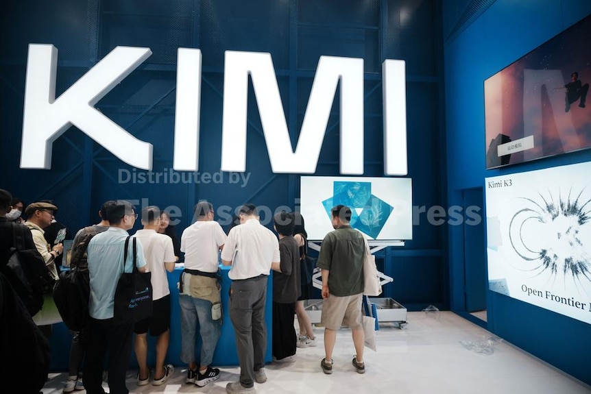 A group of people standing looking at their devices