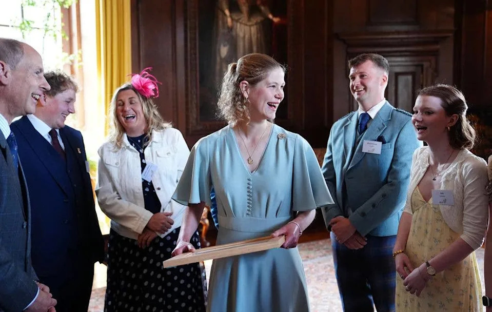 A photo of Lady Louise laughing in a group of people
